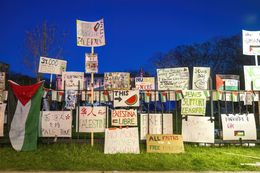 Signs protesting the war in Gaza were affixed to a fence at Northwestern University in 2024.
