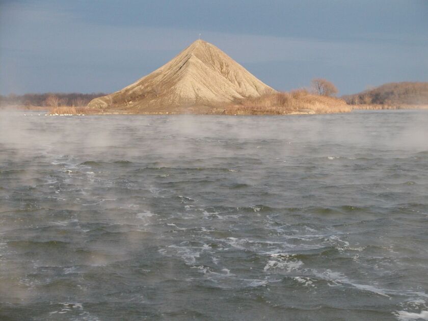 An iconic view of the island on the south end of Braidwood Lake, caught in early light as fog drifted early season in 2013.<br>Credit: Dale Bowman