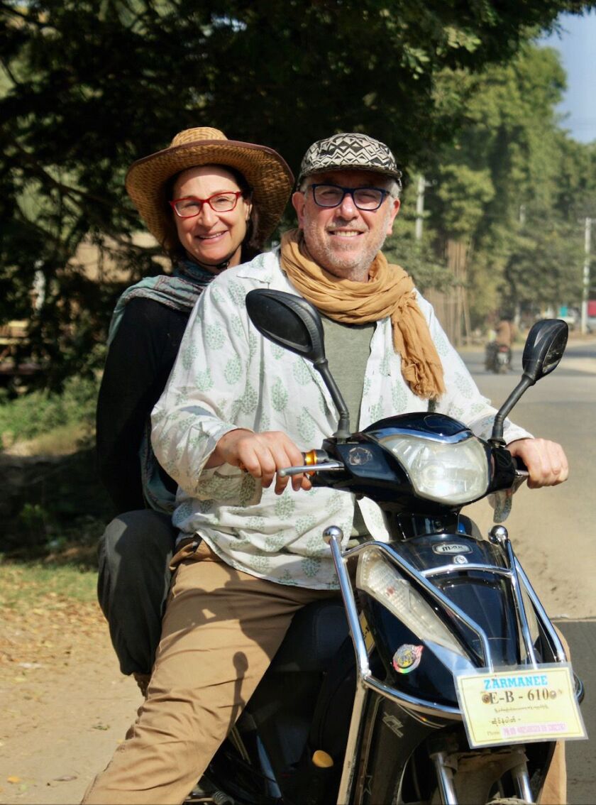 Ben Sandzer-Bell and Peta Kaplan traveling several years ago in Asia on a motorbike.