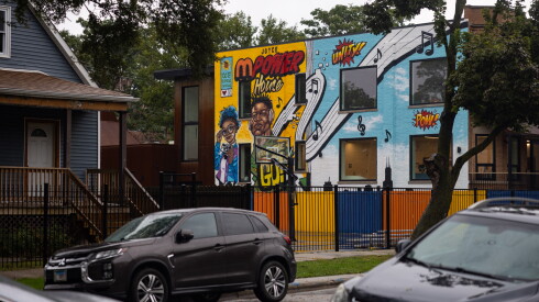 A mural showing youth as superheroes appears on the side of a building in West Englewood.