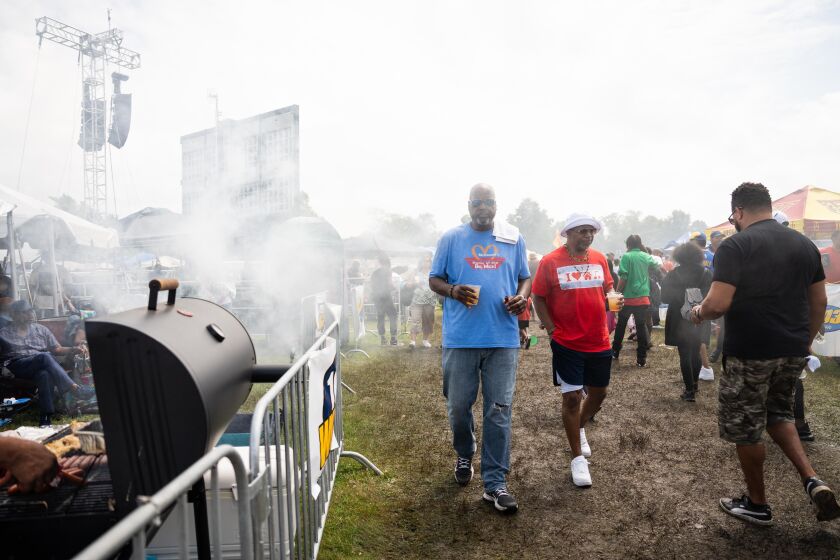 Attendees walk through smoke during the Chosen Few Picnic at Jackson Park in the Woodlawn neighborhood, Saturday, July 8, 2023. | Pat Nabong/Sun-Times