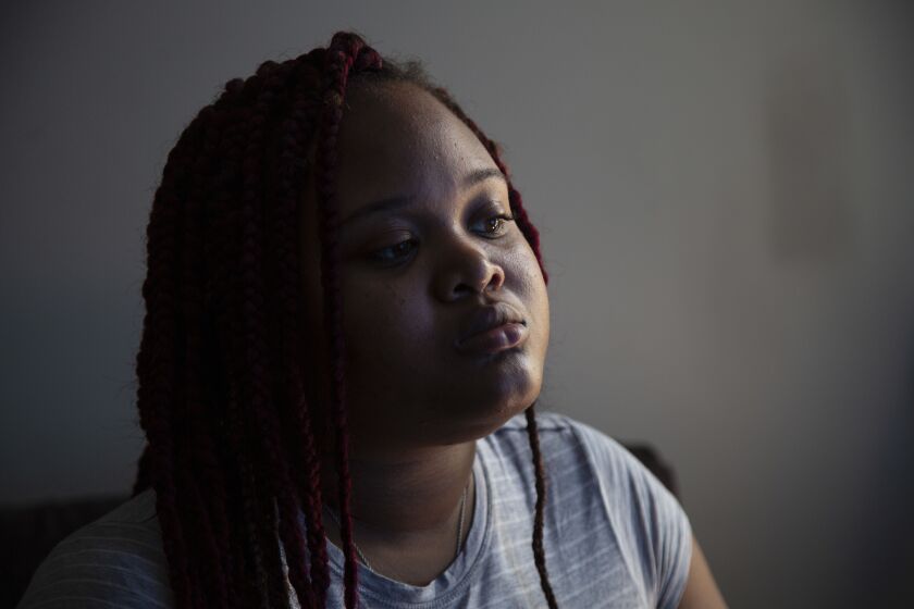 Brinity Johnson, whose mother Andrea Stoudemire was shot to death on July 26, 2019, poses for a portrait in her Englewood neighborhood apartment, Thursday, July 23, 2020. Stoudemire, 35, and Chantell Grant, a 26-year-old mother of four, were both shot to death near the base of operations for Mothers/Men Against Senseless Killings, the anti-violence group they volunteered for. No arrests have been made in connection with the incident.