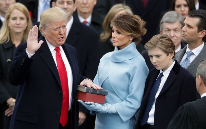 President Donald Trump takes the oath of office as his wife, Melania Trump, holds the Bible and his son Barron Trump looks on, on the West Front of the U.S. Capitol on January 20, 2017, in Washington, D.C. | File photo by Chip Somodevilla/Getty Images
