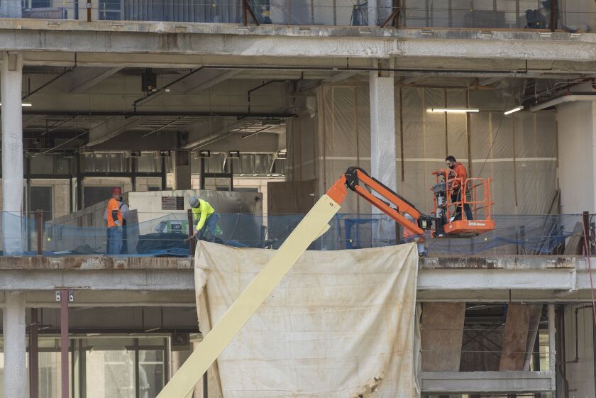 Construction crews work on a new office building at 110 N. Wacker Dr. Experts say new construction, coupled with a decline in demand from some tenants, will create a glut of office space downtown.