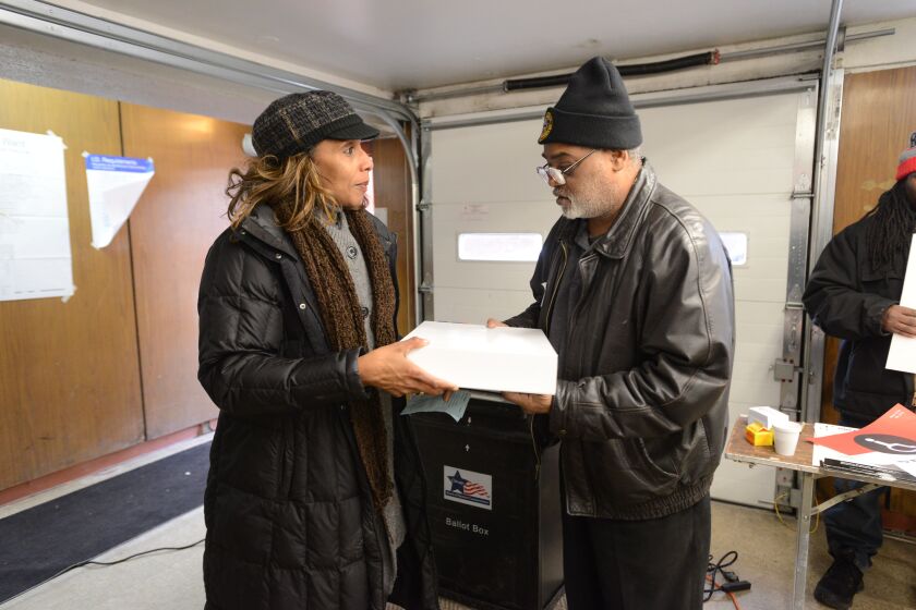 Keiana Barrett, candidate for alderman of the 7th Ward drops off donuts at 7337 So South Shore Dr. Tuesday, February 24, 2015 | Brian Jackson/ Sun-Times