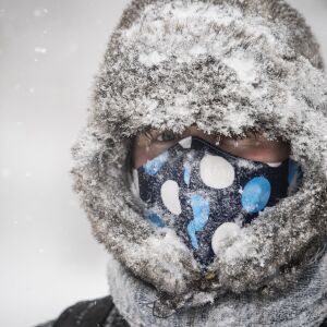 Micah Kronlokken 34, who doesn’t take public transit amid fears of the coronavirus pandemic, walks about 2 miles to his job in Rogers Park as heavy snow falls across Chicago, Monday morning, Feb. 15, 2021.