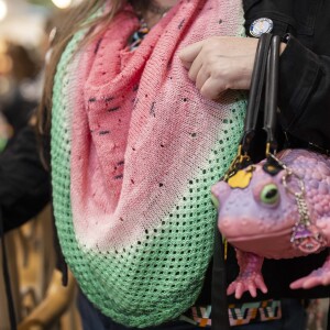 Amanda Star wears a watermelon-themed scarf that she knitted during the 19th YarnCon at the Plumbers Union Hall in the Near West Side on Saturday.