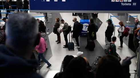 Travelers line up at a security checkpoint area in Terminal 3 at O'Hare International Airport in Chicago, Monday, Nov. 3, 2025.
