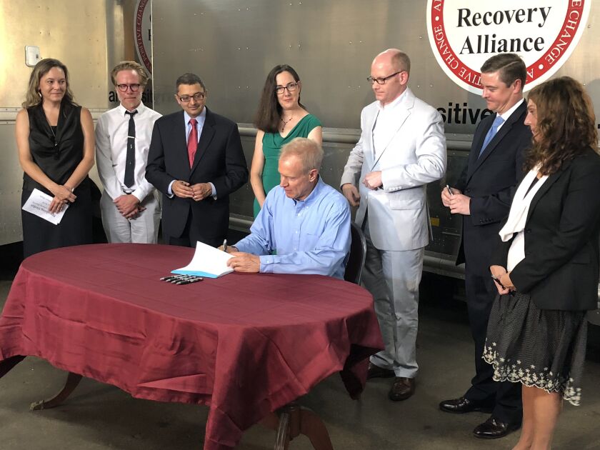 Gov. Bruce Rauner signs the Alternatives to Opioids Act Tuesday at the Chicago Recovery Alliance. | Lisa Mann for Sun-Times