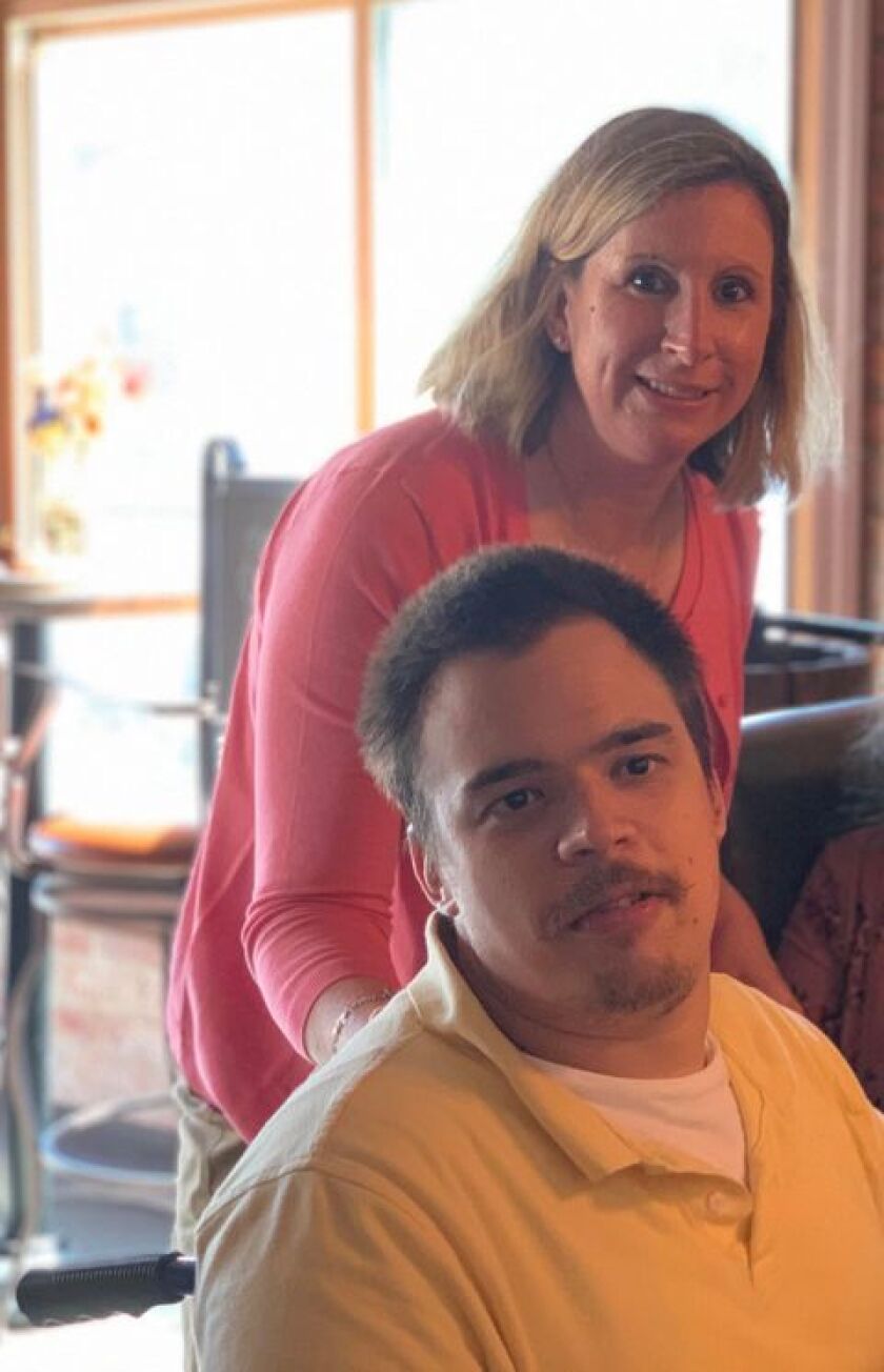 Kelly Christie with her son Keith, who she is taking care of at home after resigning from her job of 15 years.