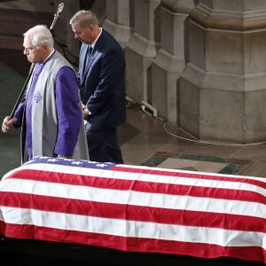 Sen. Lindsey Graham, R-S.C., is escorted to his seat after reading scripture at a memorial service for Sen. John McCain, R-Ariz., at Washington National Cathedral in Washington, Saturday, Sept. 1, 2018. McCain died Aug. 25, from brain cancer at age 81. (A