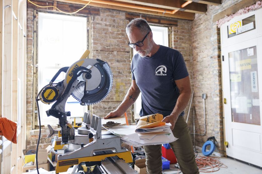Ari Smejkal gathers all his materials at a job site in Bucktown, Monday, Sept. 25, 2023
