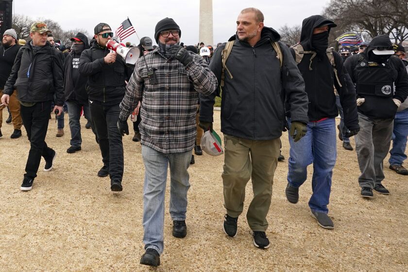 With the megaphone is Ethan Nordean, second from left. Outside pressures and internal strife are roiling two far-right extremist groups after members were charged in the attack on the U.S. Capitol. Former President Donald Trump’s lies about a stolen 2020 election united an array of right-wing supporters, conspiracy theorists and militants on Jan. 6. (AP Photo/Carolyn Kaster, file) ORG XMIT: WX203