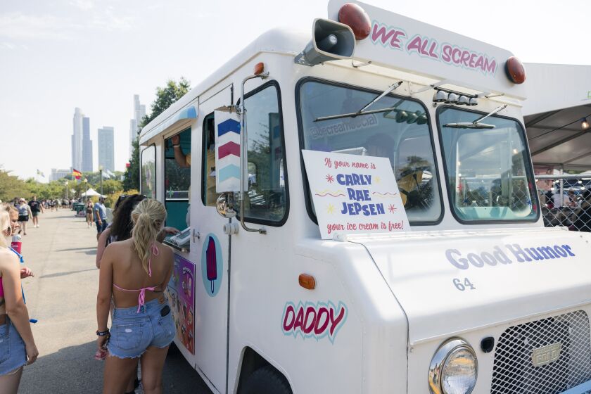 A sign for Carly Rae Jepsen proclaims she gets free ice cream if she stops by, during day one of Lollapalooza in Gran Park.