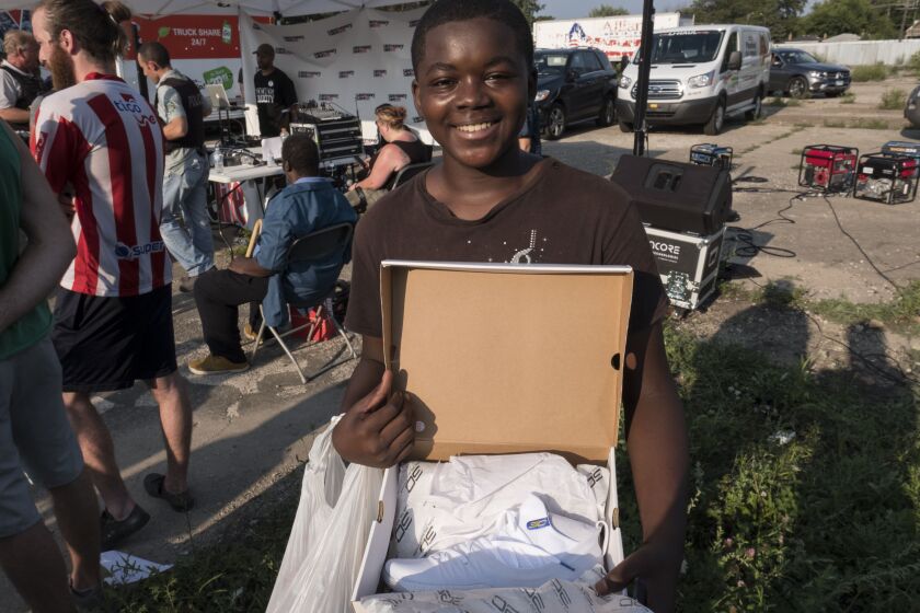 Brandon Lott, 13, poses with his new shoes that he got from Vic Mensas foundation, Save Money Save Lifes shoe give away event. | Rick Majewski/For the Sun-Times