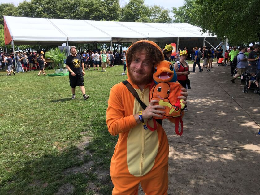 Most days, Joe Torres is a student at the University of Illinois at Chicago, studying computer science. On Saturday, he was Charmander Lives in Westchester, seen here holding War Turtle. Torres says he showed up without a ticket and that someone spotted h