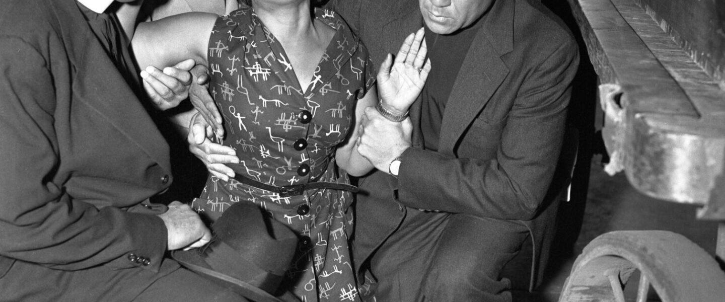 Mamie Till Mobley collapses as her son Emmett Till’s body arrives at Chicago’s old Illinois Central Railroad station after his murder by racists in Mississippi. On her left, with the white collar, is Alva Doris Roberts’ husband, Bishop Isaiah L. Roberts, who presided over the funeral. On the right, also dressed in clerical black, is Bishop Louis Henry Ford, who gave the eulogy for the slain teenager.