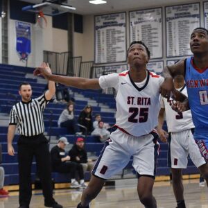 St. Rita’s Doug Posley (25) boxes out Kenwood’s Seryee Lewis (0). Worsom Robinson/For the Sun-Times.