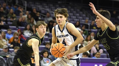 New Trier's Christopher Kirkpatrick (4) drives the ball past Lane's Luka Pinto (24) during the Hoops 4 Hunger shootout at Northwestern’s Welsh-Ryan Arena.