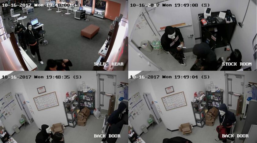 Surveillance photos of three masked suspects who robbed a cellphone store at gunpoint Monday evening in West Chicago. | West Chicago police