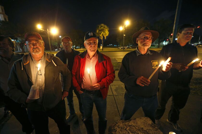 A candlelight vigil was held early Monday in New Orleans at the statue of Jefferson Davis, who served as president of the Confederate States of America during the Civil War. | Gerald Herbert/Associated Press