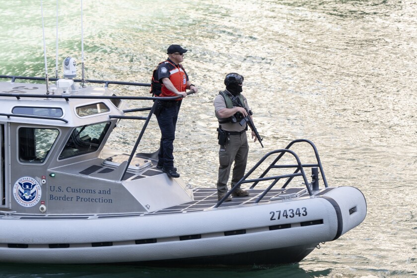 Armed federal agents ride a boat labeled “U.S. Customs and Border Patrol” on the Chicago River near North State Street and North Wabash Avenue in the Loop, Thursday, Sept. 25, 2025. | Sun-Times staff