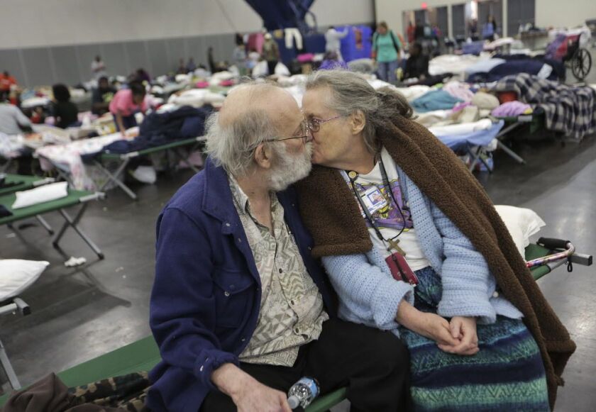Don and Peg Sauter kiss as they take refuge from Tropical Storm Harvey at the George R. Brown Convention Center in Houston on Tuesday, Aug. celebrated their 55th wedding anniversary on Aug. 22 and moved from their assisted living home. | Elizabeth Conley/