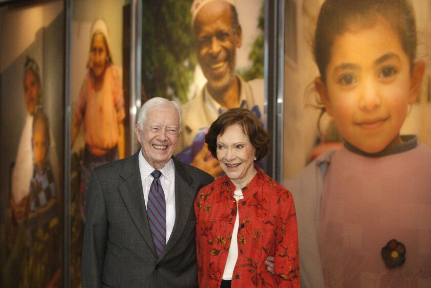 Former President Jimmy Carter and his wife, Rosalynn, look at a new interactive exhibit at the Jimmy Carter Library and Museum in Atlanta in September 2009.