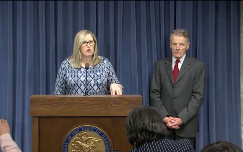 Heather Wier Vaught answers a reporter’s question as House Speaker Mike Madigan listens.