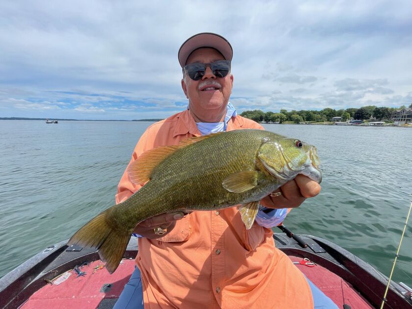 Chicagoan Charles Childes with a smallmouth bass from Big Green Lake in Wisconsin. Provided by Mike Norris