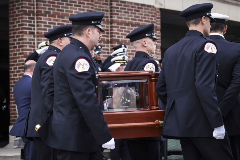 Chicago Fire Department personnel salute as pallbearers for firefighter Andrew “Drew” Price carry his remains onto a fire engine after his funeral in the Aon Grand Ballroom at Navy Pier, Monday, Nov. 20. Firefighter Price, 39, who joined the department in 2009, died Nov. 13 after he fell through a light shaft while battling a blaze in a building in the 2400 block of North Lincoln Avenue in Lincoln Park.