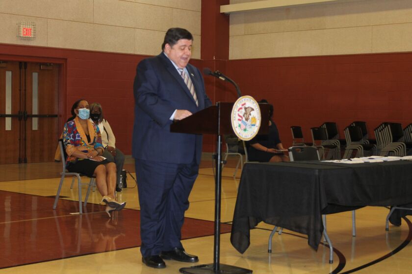 Gov. J.B. Pritzker speaks at the Union Baptist Church Gymnasium in Springfield on Tuesday.
