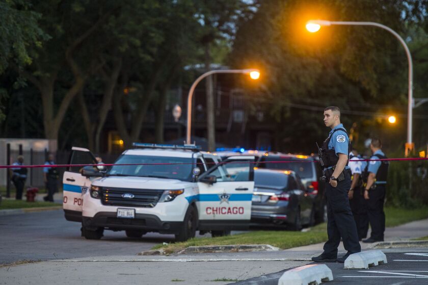 Police investigate a person fatally shot Friday morning in the 4200 block of South Cottage Grove in Chicago. | Tyler LaRiviere/Sun-Times