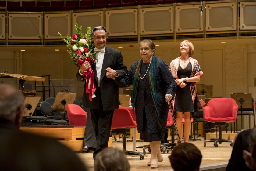 Zell Music Director Riccardo Muti escorts Irina Shostakovich, widow of composer Dmitri Shostakovich, off the stage in Orchestra Hall after their post-concert conversation following the CSO’s performance of Shostakovich’s Symphony No. 13 (“Babi Yar”), on S