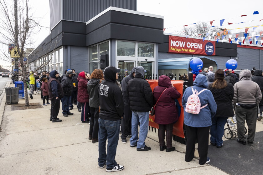 Customers line up before the opening of the renovated Save A Lot grocery store at 4439 W. 63rd St.