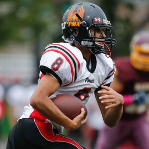 Phoenix’s Isaiah Carrasquillo (8) runs the ball during the game against Marine.