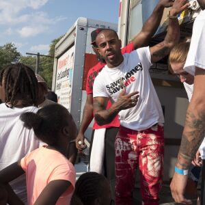 Rapper Vic Mensa hands out shoes. | Rick Majewski/For the Sun-Times