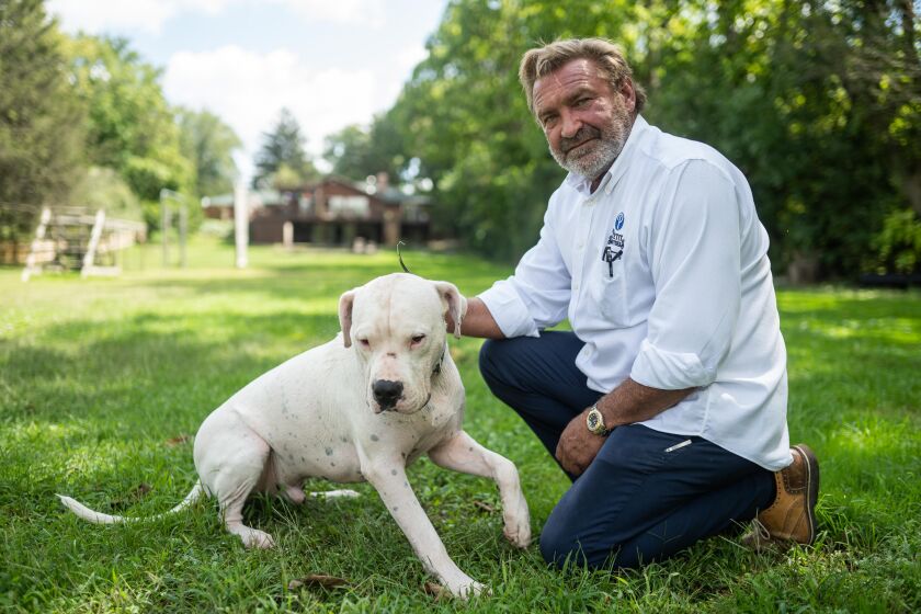 Joe Petit with his dog Philotimo in his back yard in Wayne, Ill., Wednesday morning, Sept. 1, 2021.