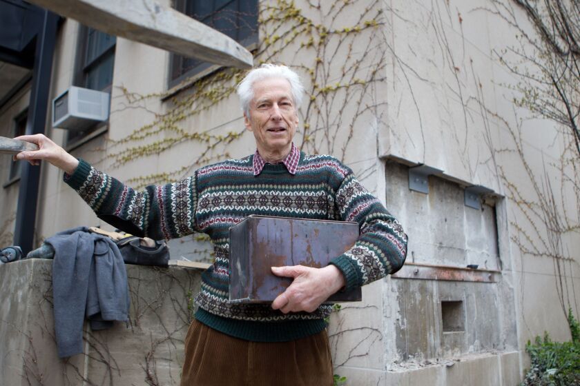 Roger Hildebrand around 2011 with a time capsule filled in the late 1940s by Enrico Fermi and other University of Chicago physicists.