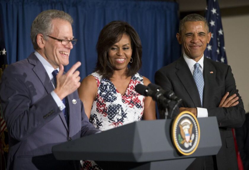 U.S. President Barack Obama makes a face toward a group of children in the audience as he stands onstage with first lady Michelle Obama and is introduced by Ambassador Jeffrey DeLaurentis, Charge dAffaires to the U.S. Embassy in Cuba, during a meeting w