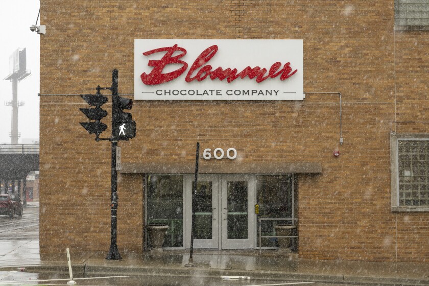 Entrance to the Bloomer Chocolate Company factory with snow falling outside.