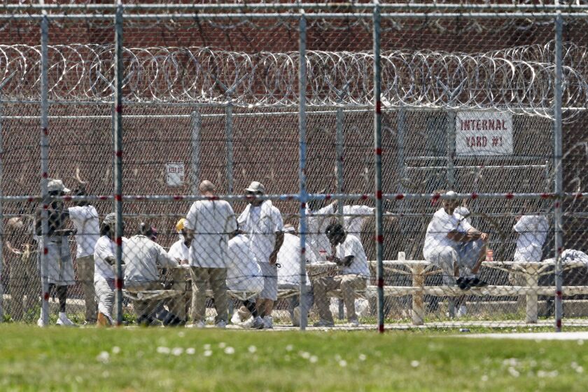 Prisoners fill a yard at the Nebraska State Penitentiary in Lincoln, Neb. Nebraska’s prisons are facing a persistent staffing crisis.