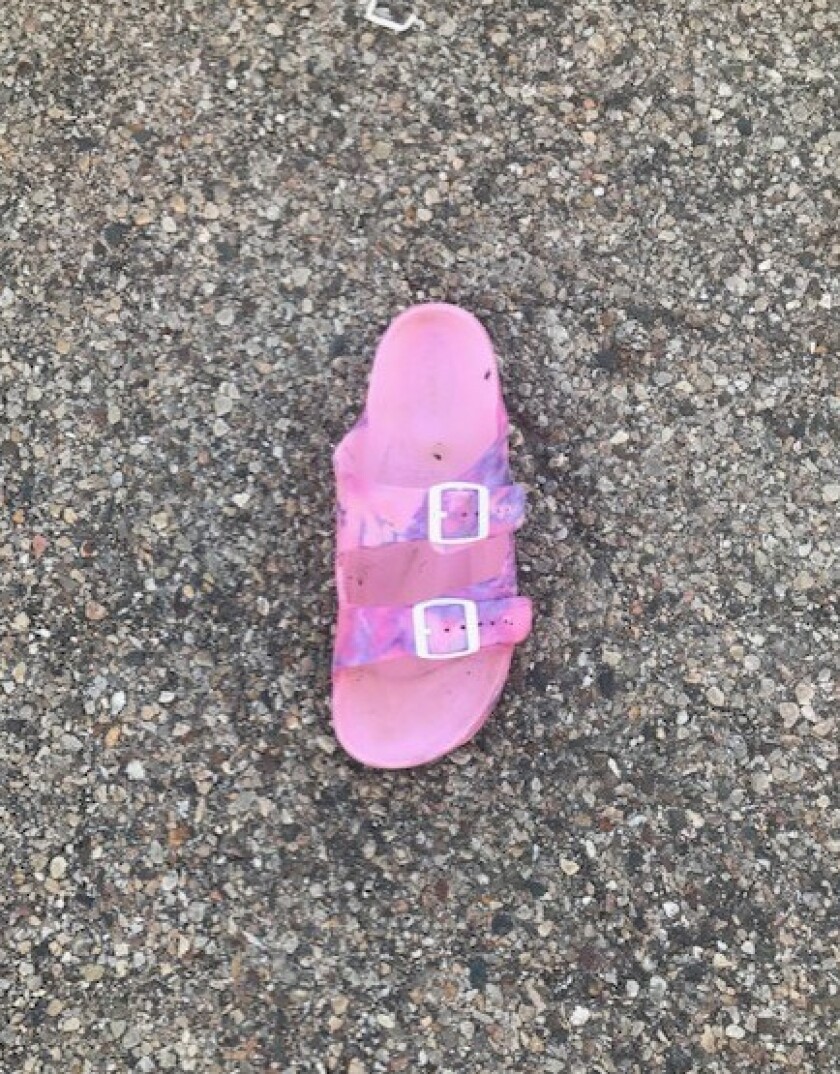 A pink tie-dye sandal was found near the scene where a teenage girl was kidnapped June 14, 2021 in Peru, Illinois.