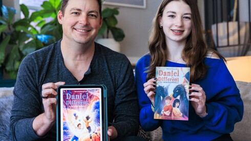 Authors and Father and daughter Ty Thompson (left) and Vaughn Thompson hold up their two books at their home in Lakeview, Friday, March 27, 2026. The Father and daughter have written two books tougher, “Daniel the Different” which they hope to turn into a trilogy. | Anthony Vazquez/Sun-Times