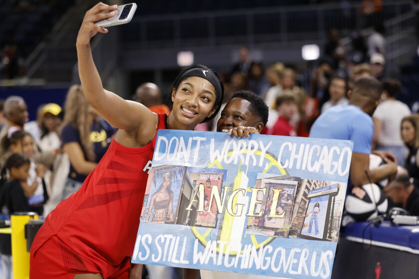 Angel Reese of the Atlanta Dream takes a selfie with a fan after the game against the Sky at Wintrust Arena on June 9, 2026.