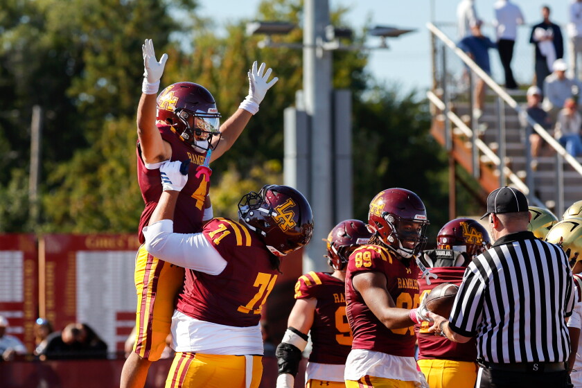 Loyola's Melo Maldonado (4) is celebrated by teammates after scoring a touchdown against St. Ignatius.