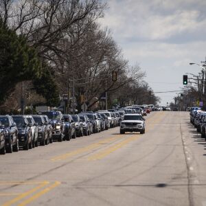 Hundreds of law enforcement officers sit in their vehicles along West Lawrence Avenue, as only family members were permitted inside Cumberland Funeral Chapels for Chicago Police Officer Marco DiFranco, Thursday, April 9, 2020.