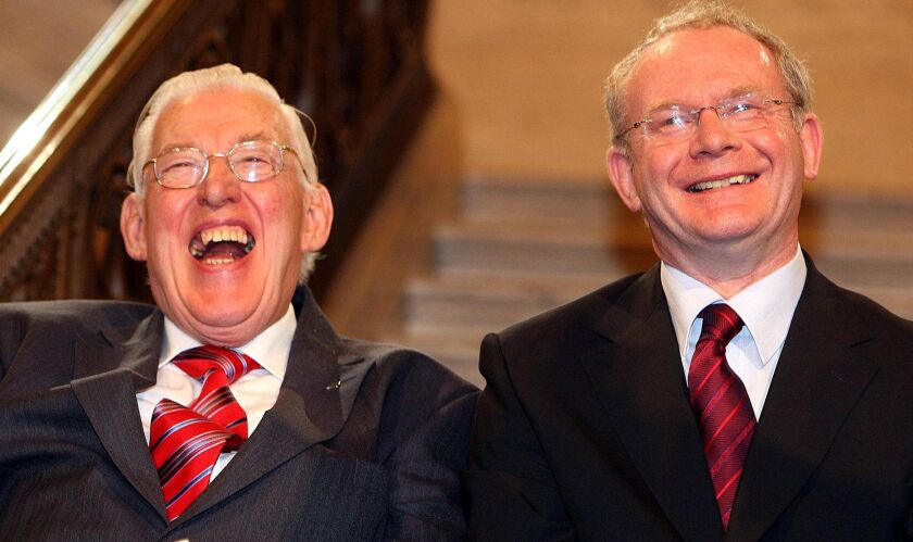 Northern Ireland’s First Minister Ian Paisley (left) and Deputy First Minister Martin McGuinness smile after being sworn in as ministers of the Northern Ireland Assembly, at Stormont Parliamentary Building, Belfast, Northern Ireland in 2007. | Associated
