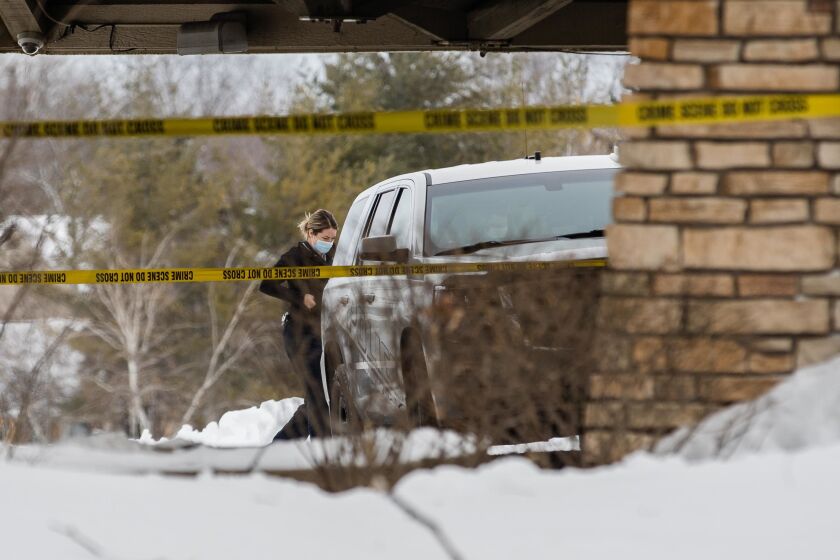 A police officer walks outside the Indian Lakes Hotel at 250 W. Schick Road Saturday morning after a fatal shooting.