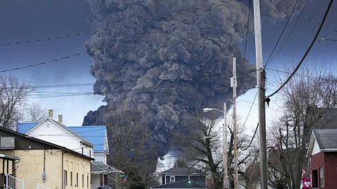 A black plume rises over East Palestine, Ohio, as a result of a controlled detonation of a portion of the derailed Norfolk Southern trains on Feb. 6.